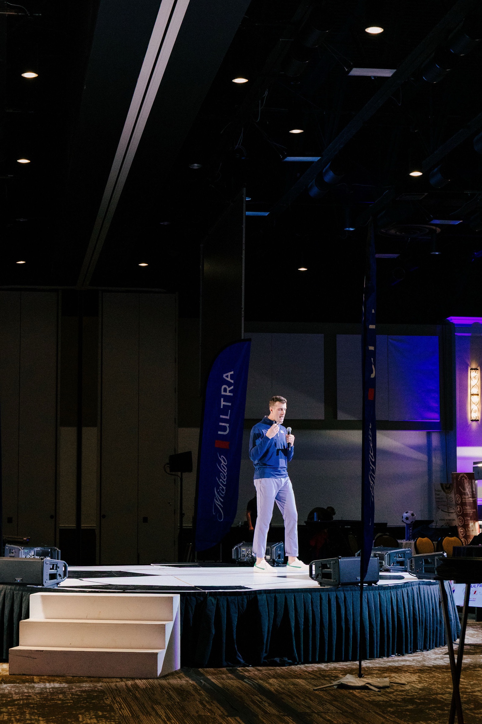 Speaker presenting on the soccer-ball stage at the Michelob Ultra World Cup launch produced by Klock Events